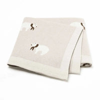 Beige cotton baby blanket for infants with white polar bear design and soft texture