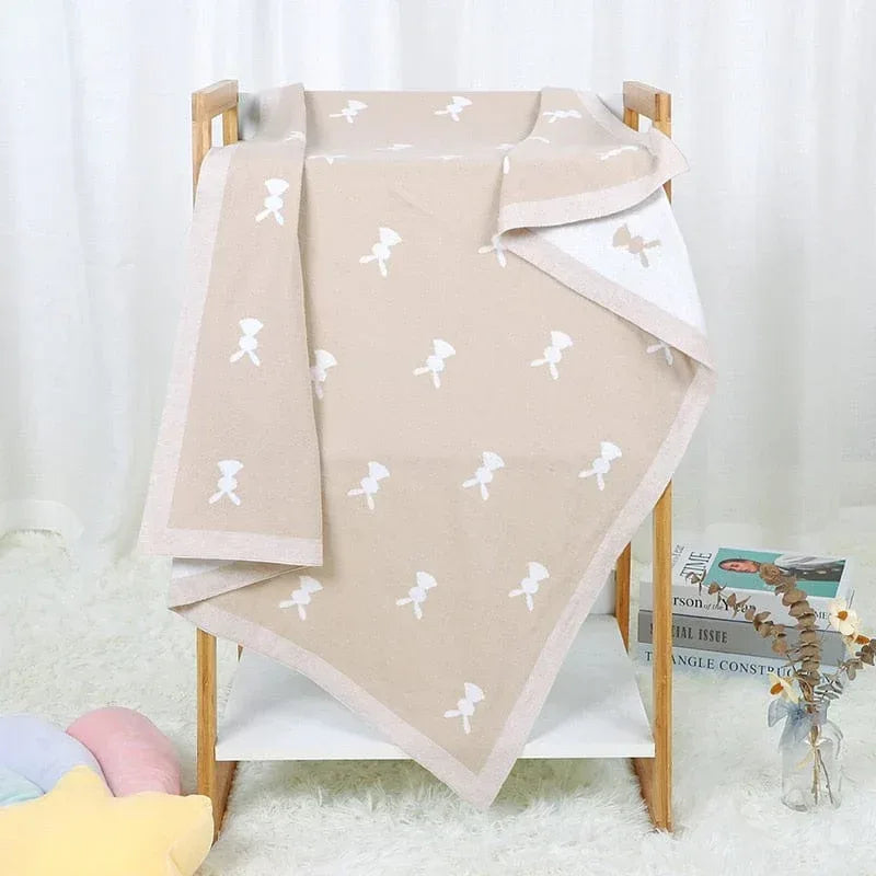 Soft baby bunny blanket in beige with white bunny pattern, suitable for newborns and toddlers