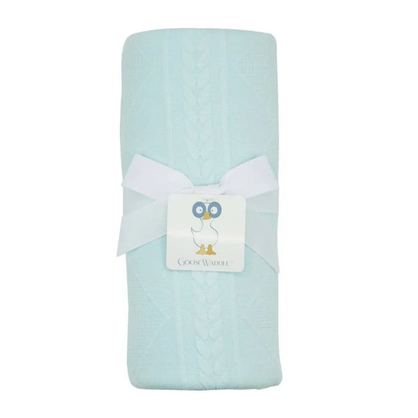 Mint knit baby blanket for newborns folded with white ribbon bow and Goosewaddle tag