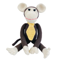 Handmade brown crocheted monkey toy with big ears and yellow tie. Organic cotton stuffed animal for nursery decor and pretend play.