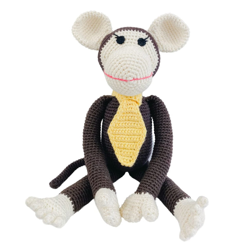 Handmade brown crocheted monkey toy with big ears and yellow tie. Organic cotton stuffed animal for nursery decor and pretend play.