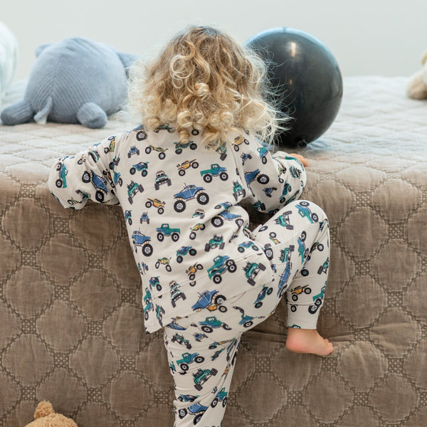 Toddler wearing a monster truck print jogger set with a cozy crew neck top and matching pants.