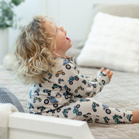 Toddler wearing a cozy monster truck print crew neck jogger set with matching pants for playful comfort.
