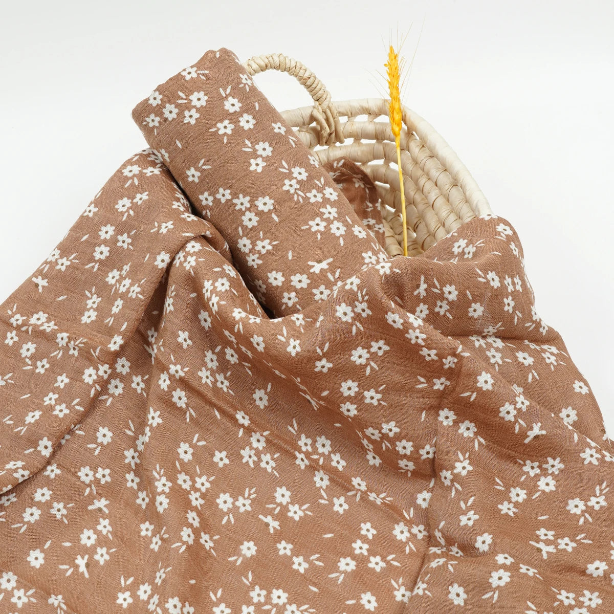 Brown muslin swaddle with white floral print for babies, soft breathable fabric accessory