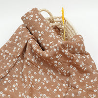 Brown muslin swaddle with white floral print for babies, soft breathable fabric accessory