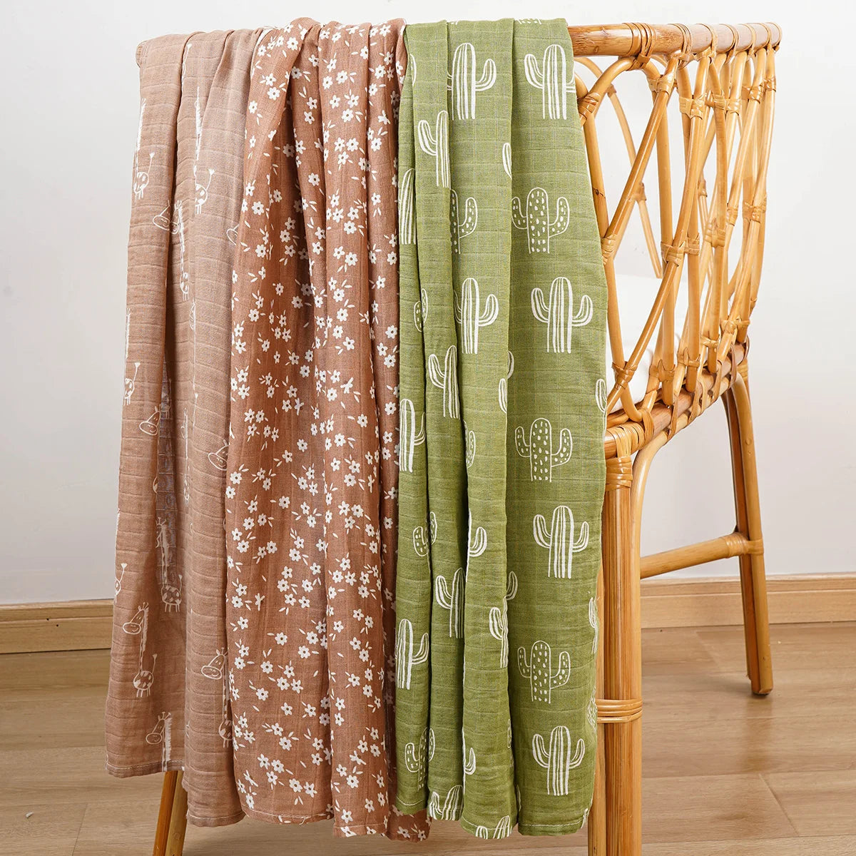 Set of beige and green muslin swaddle blankets for babies with floral and cactus prints