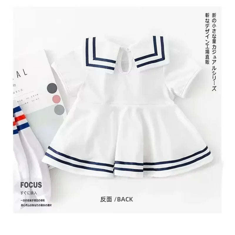 white nautical baby dress for infants with navy blue stripes and sailor collar detail