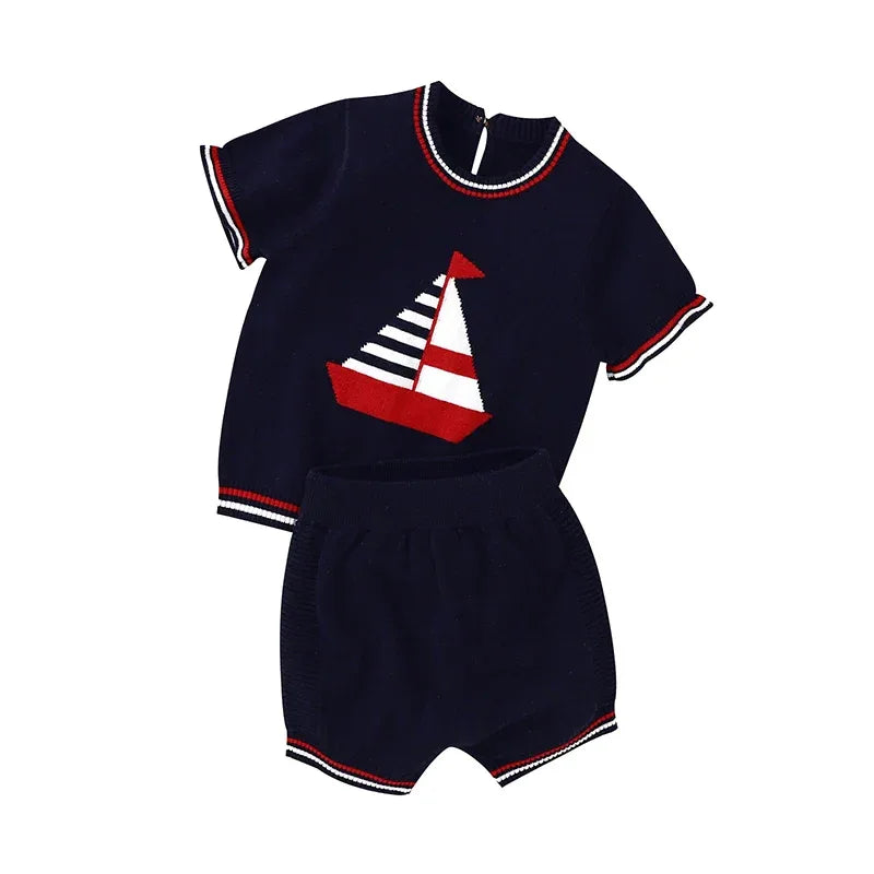Navy blue nautical baby outfit with short sleeves and sailboat design, includes matching shorts
