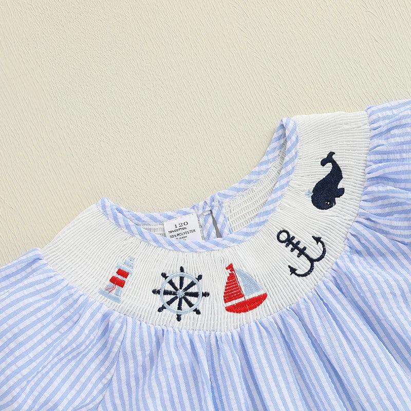 Light blue and white striped nautical dress for babies with embroidered sea motifs on collar