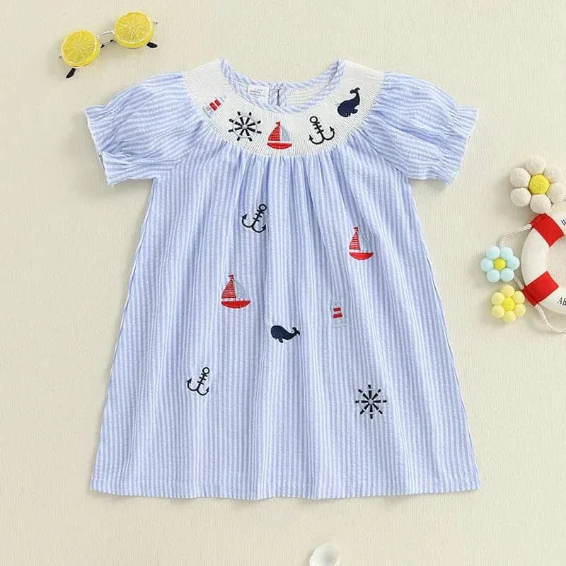 blue and white nautical smocked dress for girls with red sailboats and anchors for toddlers