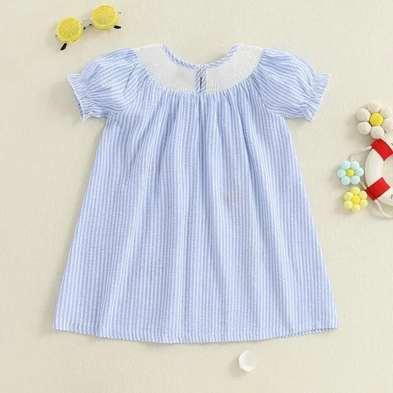 light blue nautical smocked dress for girls with white collar, laid flat for baby or toddler