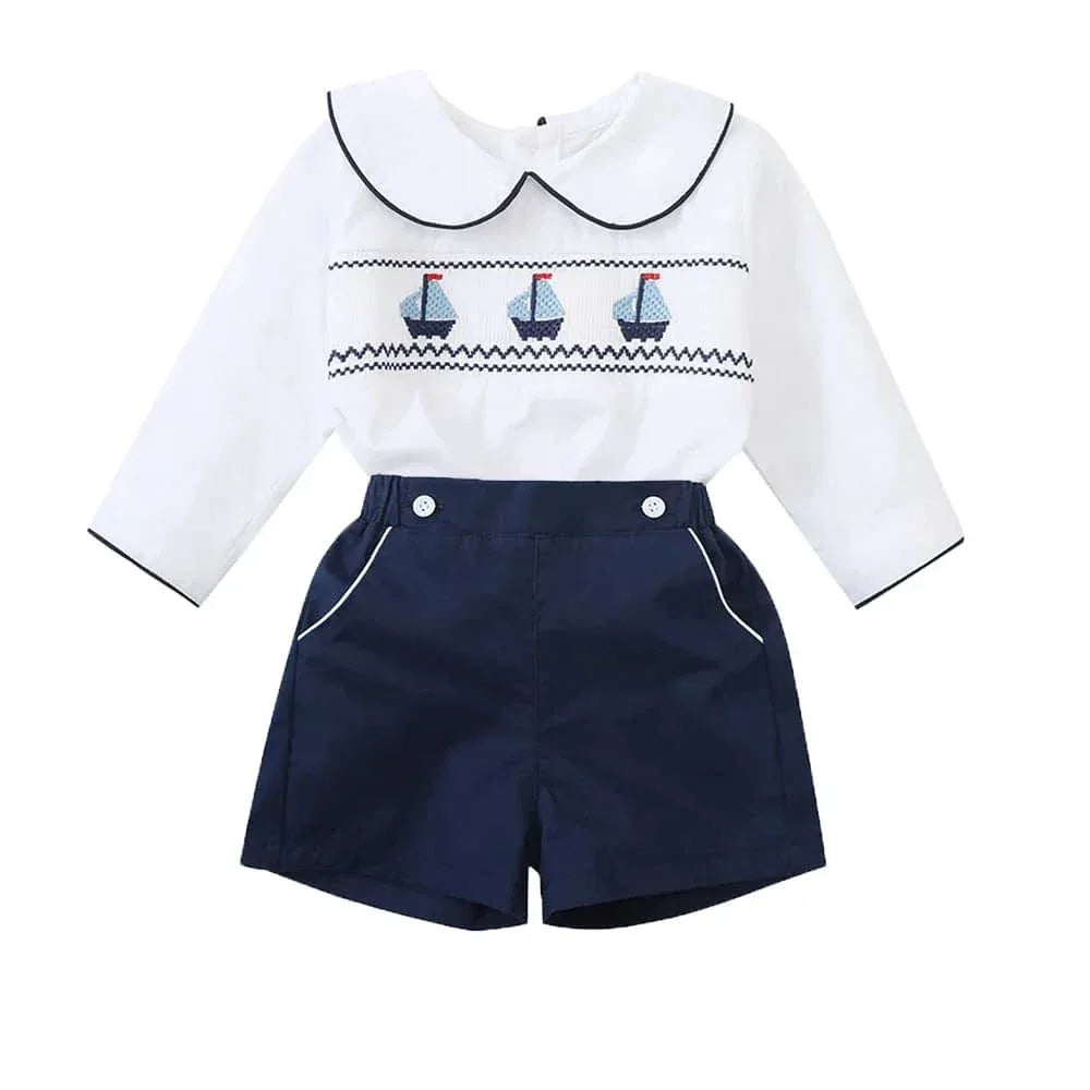 nautical smocked romper for baby boys with white long sleeves and navy shorts size newborn