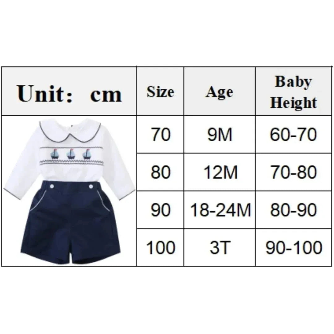 nautical smocked romper for baby boys in white and navy blue for ages 9 months to 3 years