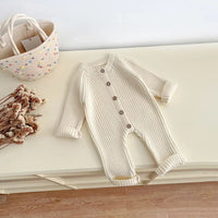 neutral baby romper knit 3-24 months in cream color with button front and long sleeves