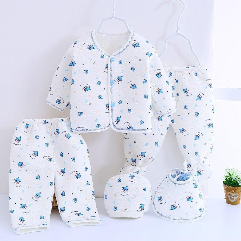 White newborn baby layette set with blue sailboat prints including jacket, pants, hat, and bib for infants