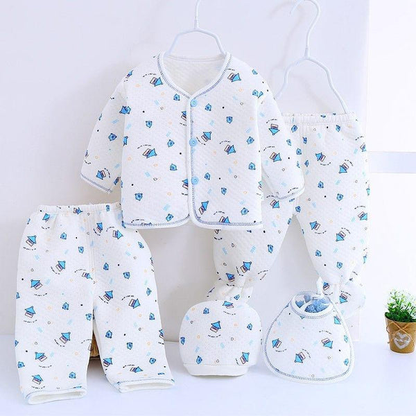 White newborn baby layette set with blue sailboat prints including jacket, pants, hat, and bib for infants