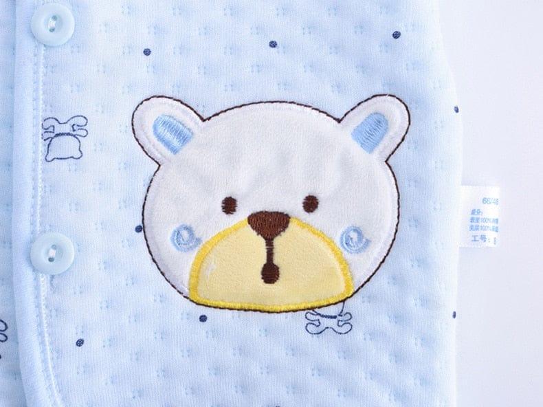 Light blue newborn quilted layette set with textured fabric and embroidered bear face detail