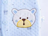 Light blue newborn quilted layette set with textured fabric and embroidered bear face detail