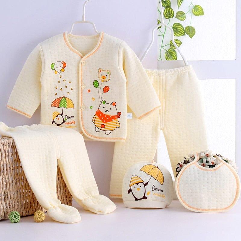 Cream newborn quilted layette set for babies with embroidered animal designs and matching hat and bib