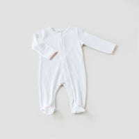 White baby pink newborn Take Me Home gown with long sleeves, footies, and delicate pink trim detailing for elegant新生儿 comfort.