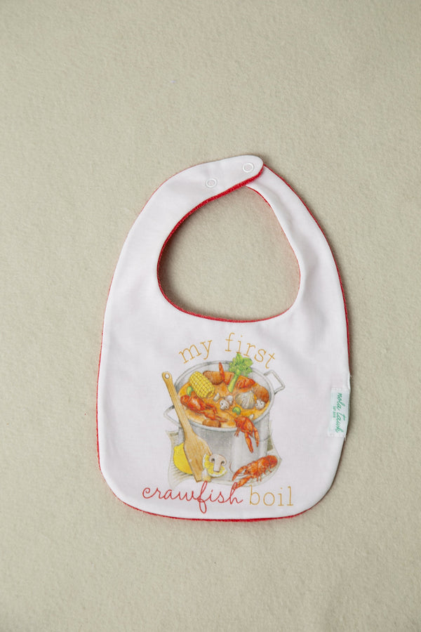 My First Crawfish Boil Organic Cotton Baby Bib with red trim and seafood illustration.