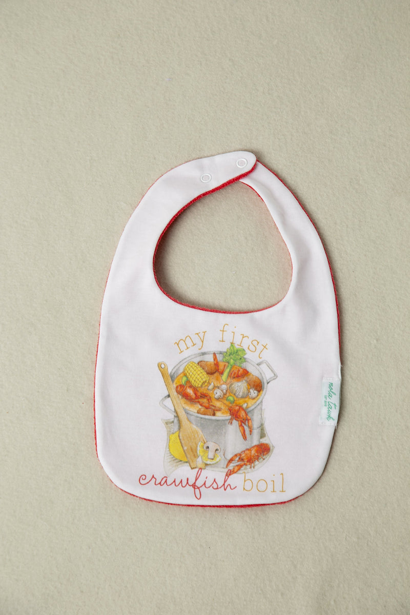My First Crawfish Boil Organic Cotton Baby Bib with red trim and seafood illustration.