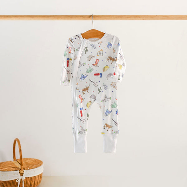 Texas Kids Organic Cotton Sleepwear on hanger; white sleeper with Texas prints, newborn gown, zip, or two-piece set.