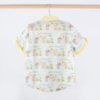 Children's shirt with animal pattern on a hanger against a white background