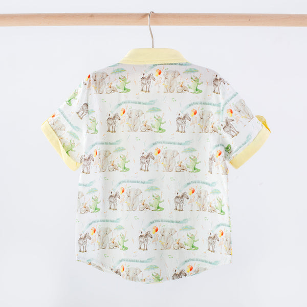 Children's shirt with animal pattern on a hanger against a white background