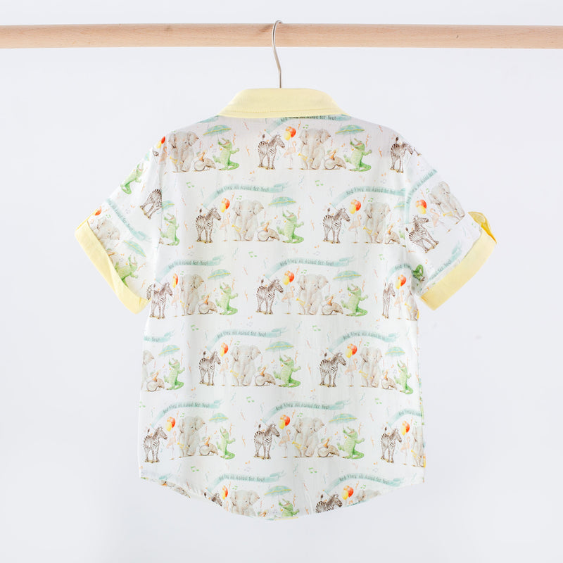 Children's shirt with animal pattern on a hanger against a white background
