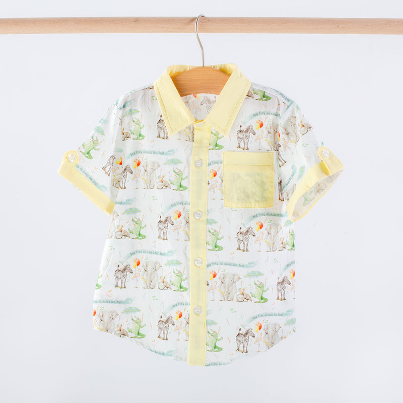 Children's shirt with animal pattern and yellow accents on a hanger against a white background