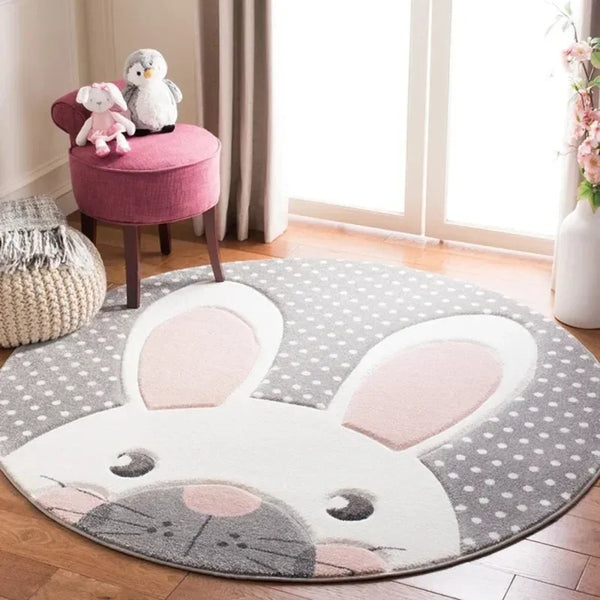 Round gray and white nursery rug with pink bunny ears and polka dots for baby room