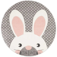Round grey and white baby nursery rug with pink bunny ears and polka dot background