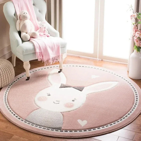 Round pink nursery rug with white bunny face and heart details for baby room