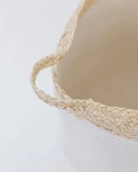 Macro view of braided natural seagrass handle loop attached to the driftwood accent home basket rim