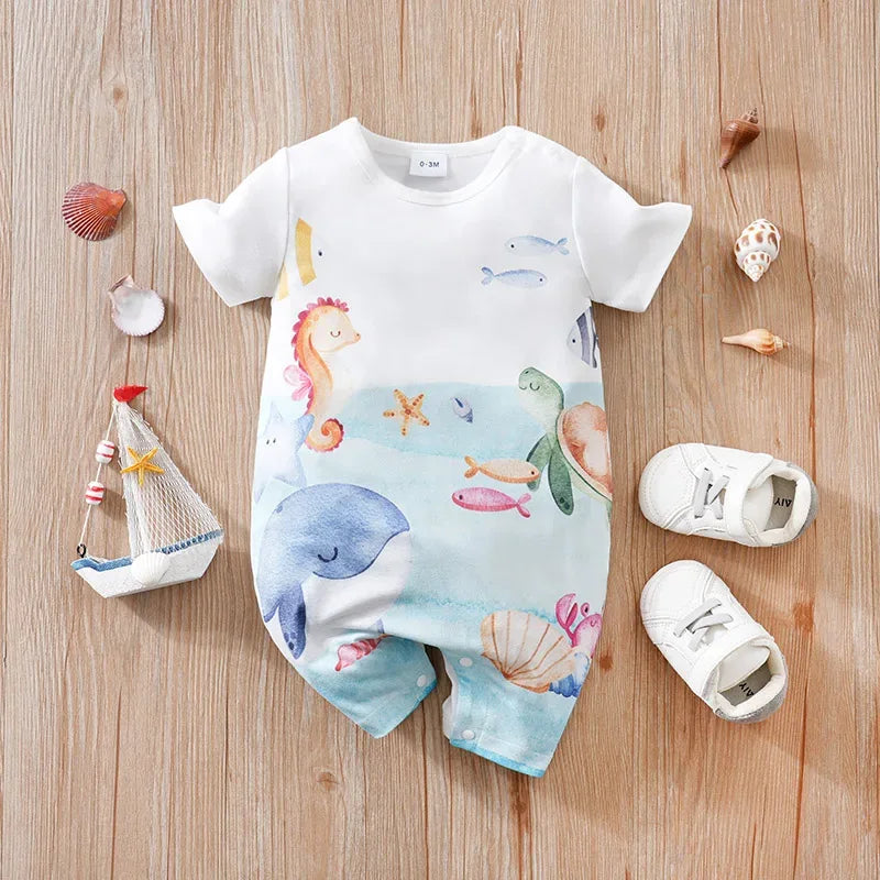 White cotton ocean themed baby romper with colorful sea creatures print including whale, seahorse, and turtle