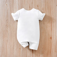 White cotton ocean themed baby romper with short sleeves on wooden background