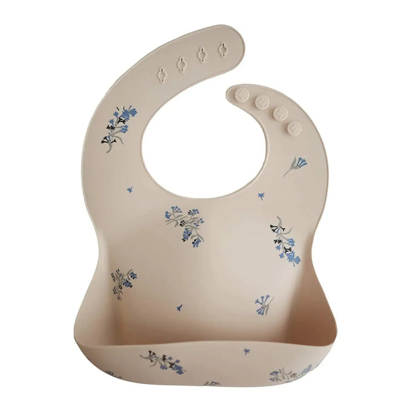 Beige waterproof baby bibs with blue floral pattern and adjustable neck buttons for infants