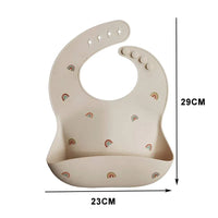 Beige waterproof baby bibs with rainbow prints for infants measuring 23 by 29 centimeters