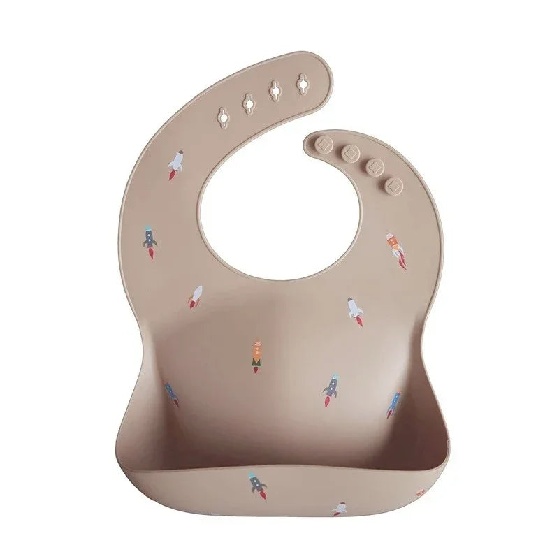 Beige waterproof baby bibs with colorful rocket designs for infants and toddlers
