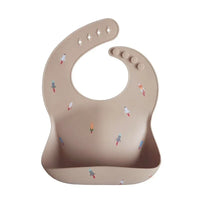 Beige waterproof baby bibs with colorful rocket designs for infants and toddlers