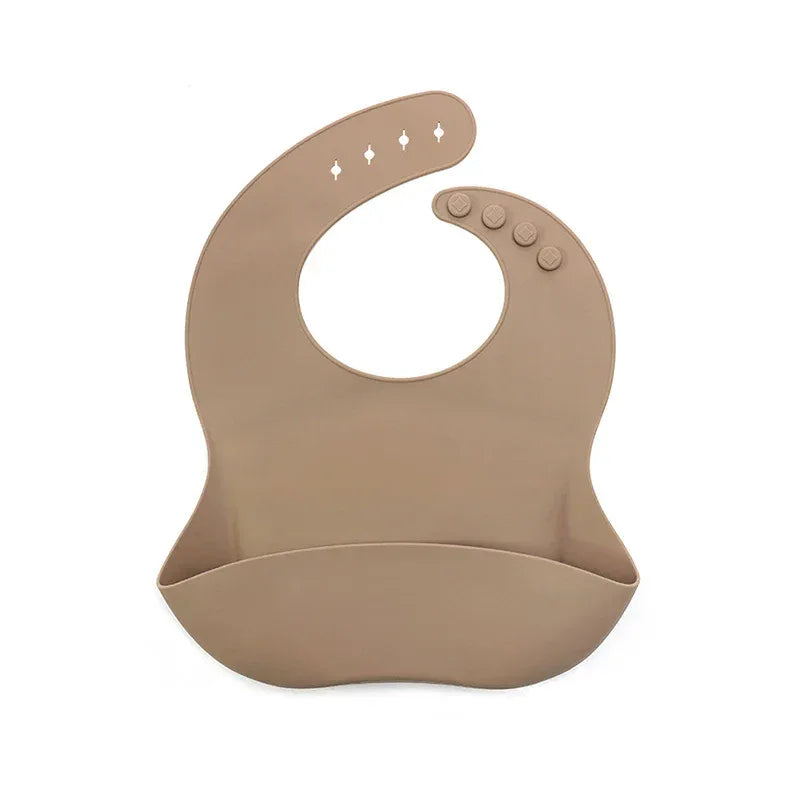 tan waterproof baby bib for infants with adjustable button neck closure and food catcher pocket