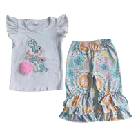 White baby pant set with ruffle sleeves and colorful bunny applique paired with patterned ruffle pants
