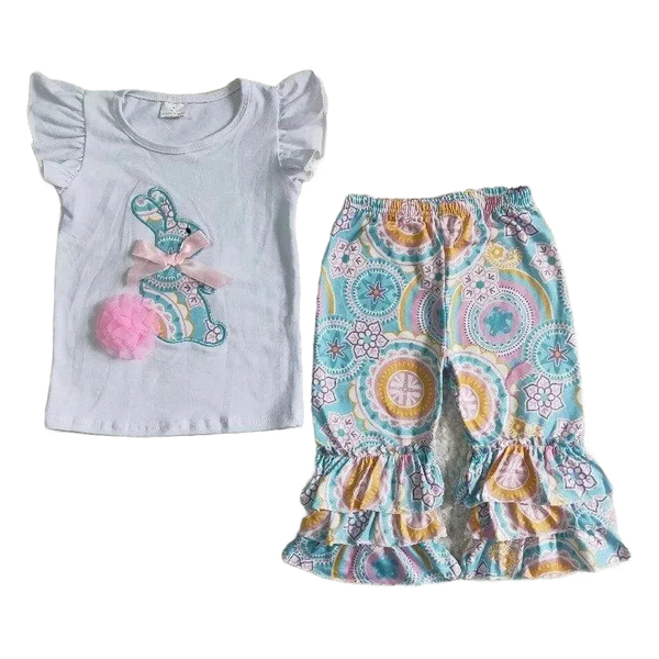 White baby pant set with ruffle sleeves and colorful bunny applique paired with patterned ruffle pants