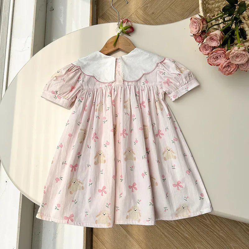 baby pink party dress with white collar and puff sleeves featuring bear and bow prints