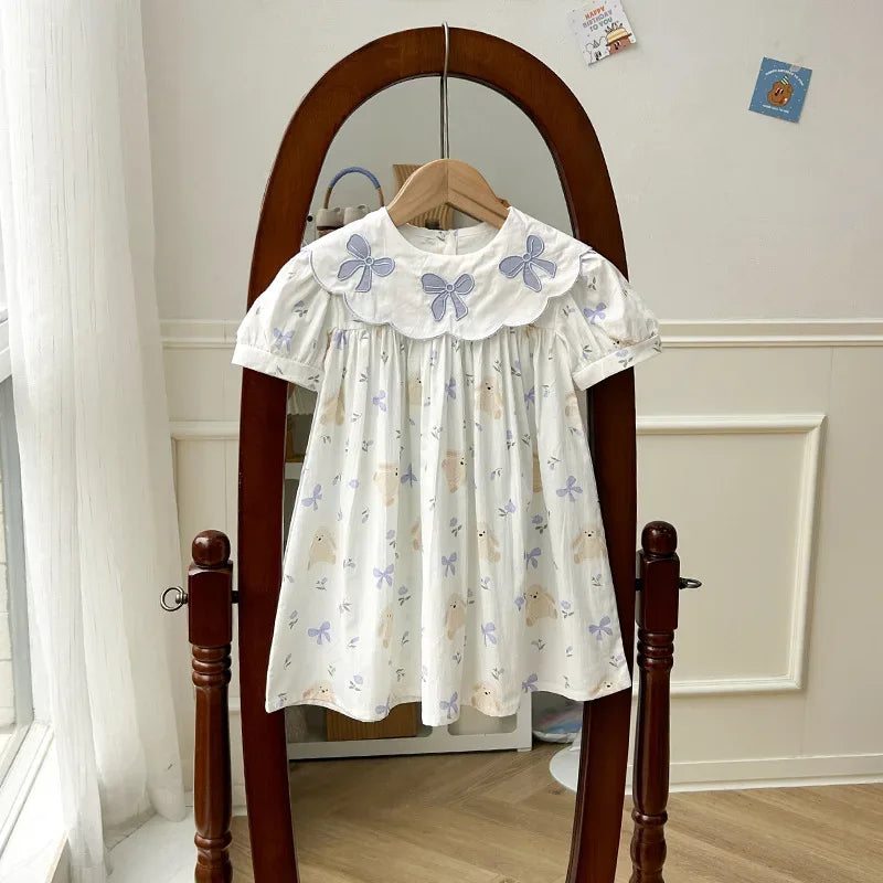 baby girls white party dress with purple bow prints and scalloped collar for infants