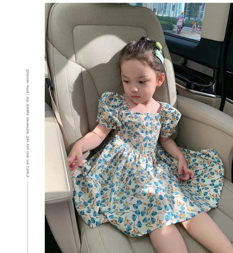 toddler girl party dress in white with blue floral pattern and puff sleeves