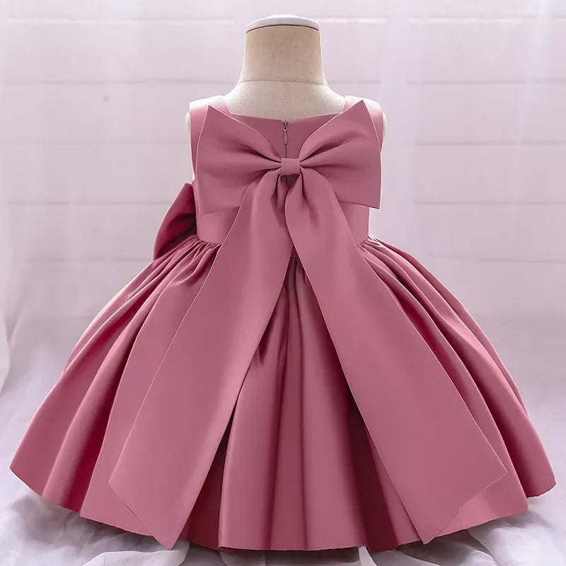 baby pink sleeveless party dress with large bow back detail for toddlers