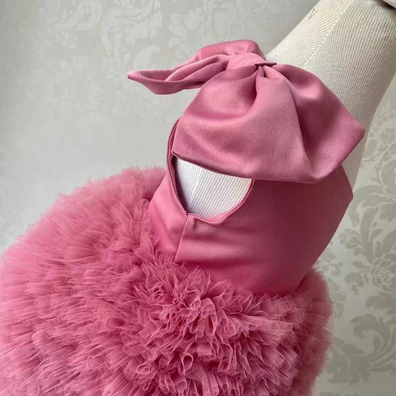 pink party dress for toddlers with large bow and fluffy tulle skirt detail