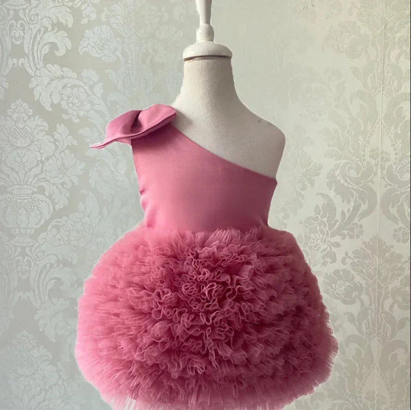 baby pink party dress with one shoulder and fluffy tulle skirt for infants and toddlers